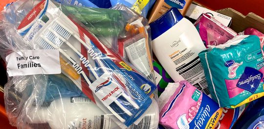 A care bag for a family which contains hygiene and self care products
